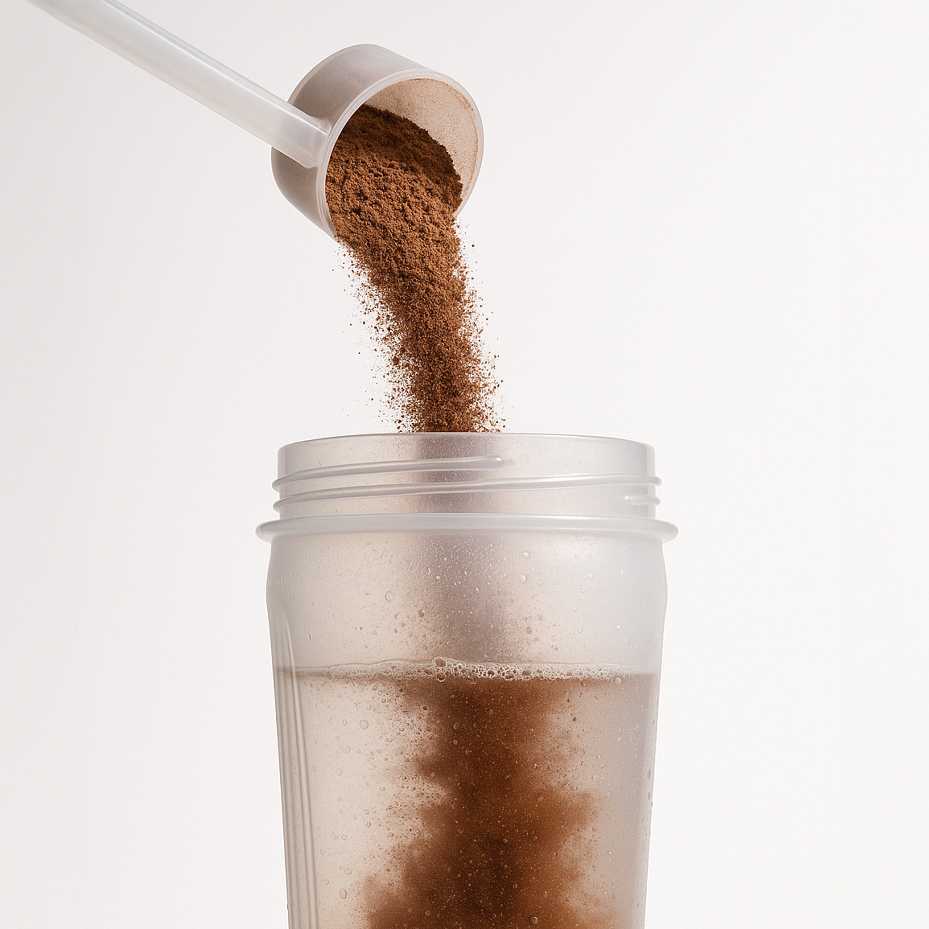 SP50 chocolate protein powder pouring from scoop into a shaker cup, showing easy mixability.