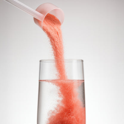 ThermalBurn16 powder pouring from scoop into water, showing easy mixability.